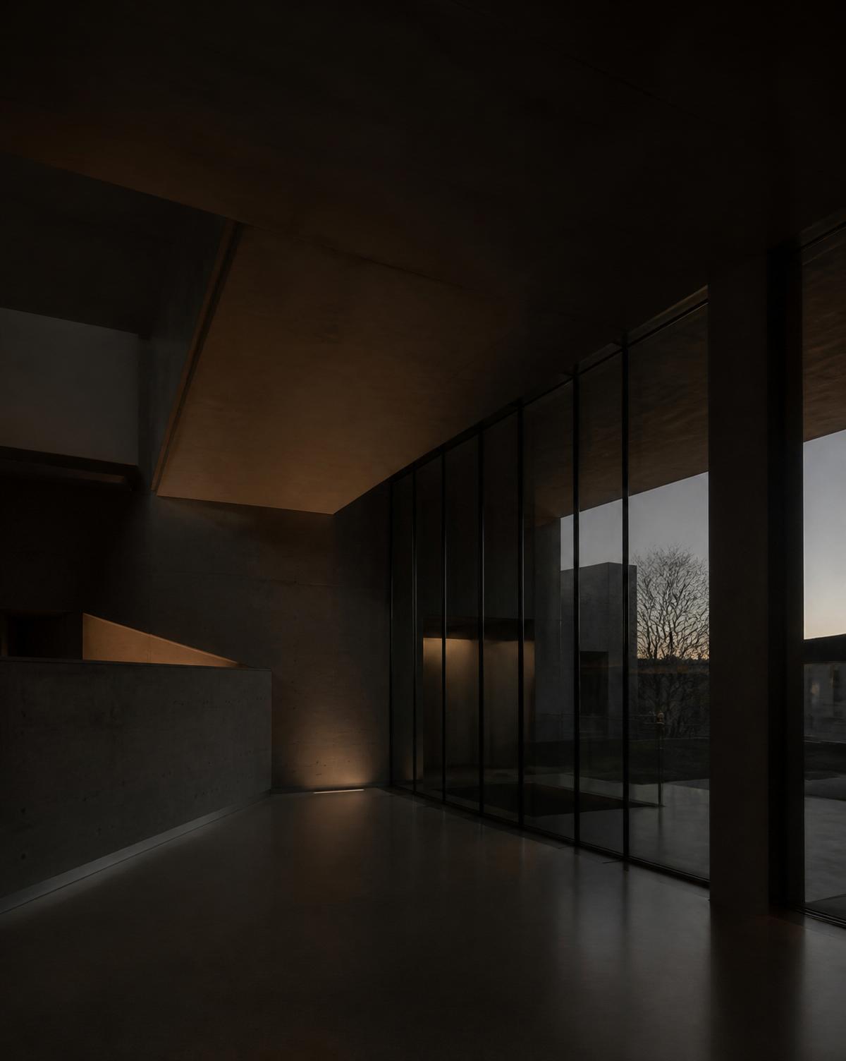 A quiet concrete and glass interior in the Stuttgart region at dusk